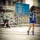 Girl with camera, man with bikes