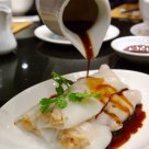 pouring soy bean sauce onto Chinese dim sum