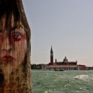 painted face on wooden post