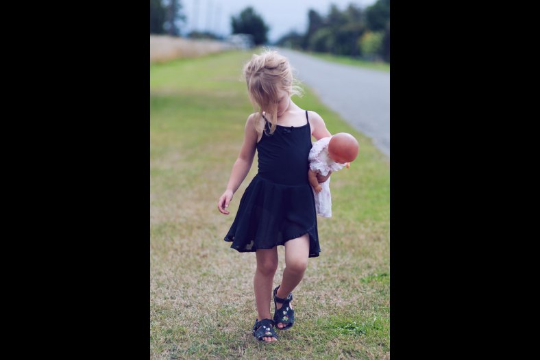 Little girl taking her doll to ballet class