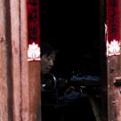 A lady doing needlework in a town of Lijiang