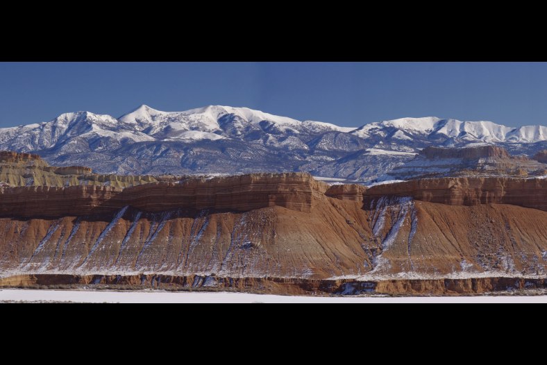 Wildcat Mesa in front of Snow Caped Henry Mountains 