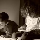 Childrens reading a book before sleep
