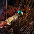 master working on an old loom