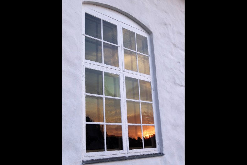 Sunset reflected in churchwindow